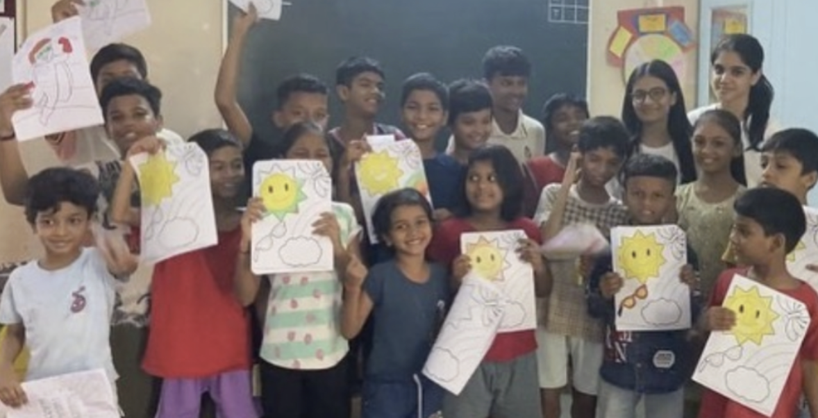 Children holding up artwork during a mental health activity at RKSS NGO