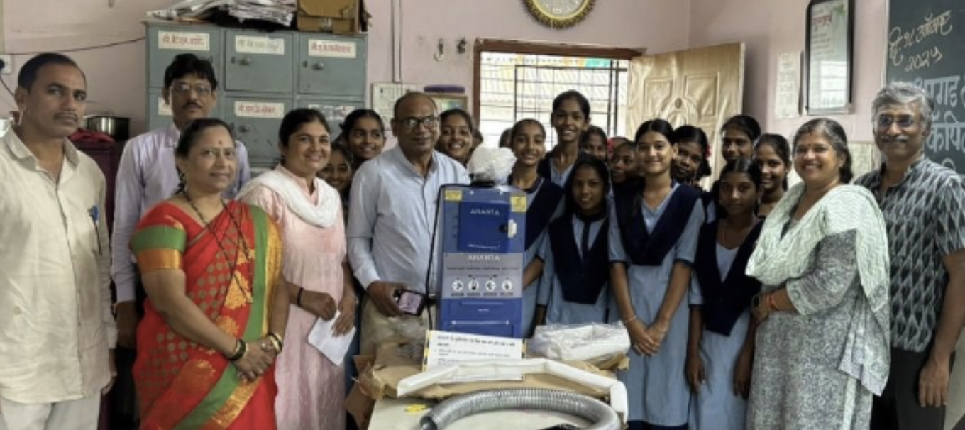 Healing Hearts Foundation members with teachers and students of Jagruti High School gathered around the newly donated sanitary pad incinerator.