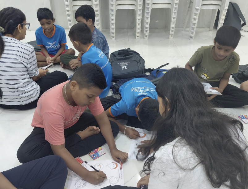 Children colouring emotion worksheets with Healing Hearts facilitators at Angel Xpress Foundation