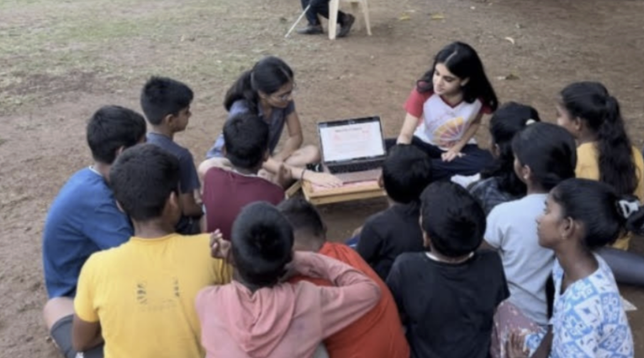 Facilitators discussing menstrual health with a circle of children at Down To Earth NGO